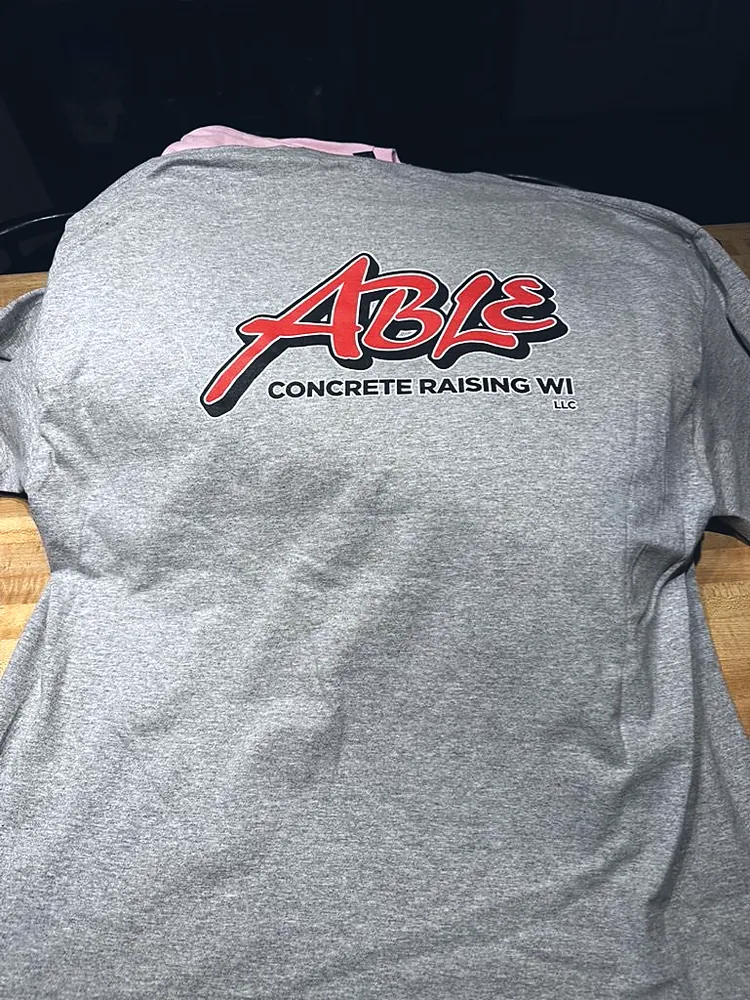 Gray work t-shirt with a full-color Able Concrete Raising WI logo printed on the back, custom company shirts in Wausau, WI