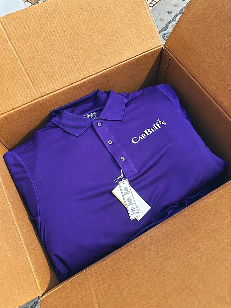 Purple performance polo with a white CarBuff's logo on the chest, custom company apparel from Patch Adams Promo in Wausau, WI