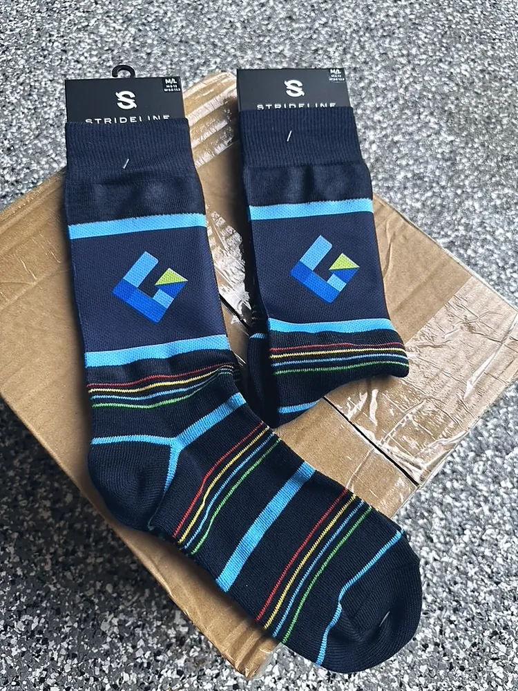 Navy striped crew socks with a custom blue and green logo, promotional socks from Patch Adams Promo in Wausau, WI