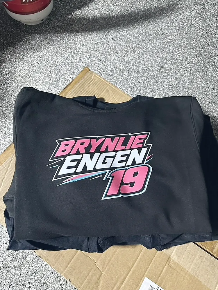 Black tee with a pink, white and blue racing team design printed in full color, custom race team apparel from Wausau, WI