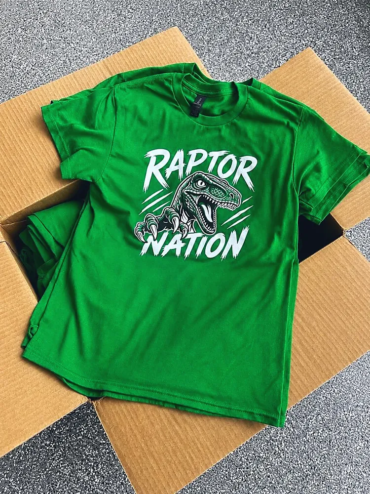 Green Raptor Nation school spirit t-shirt with a white and black dinosaur design, custom team apparel from Wausau, WI