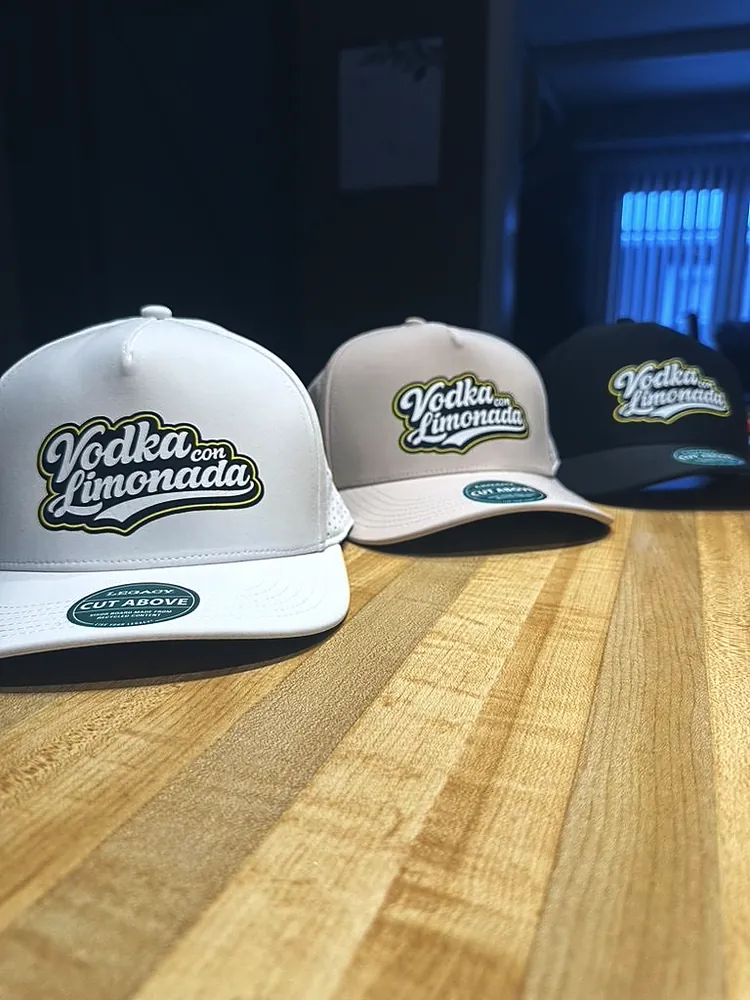 White, tan and black caps with the Vodka con Limonada logo, custom headwear from Wausau, WI
